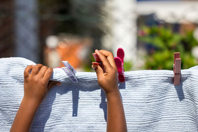 Girl hanging laundry outdoors