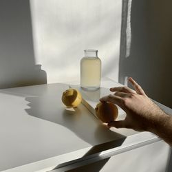 Person holding fruit on table