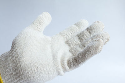 Close-up of human hand over white background