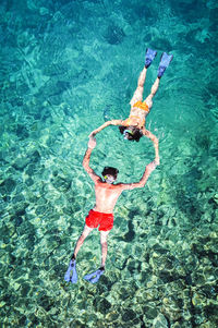 High angle view of man swimming in sea