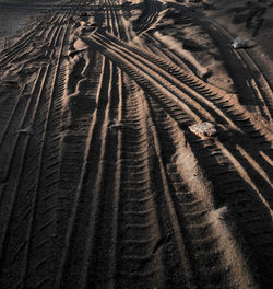 Full frame shot of tire tracks on sand