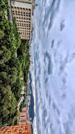 Buildings against cloudy sky