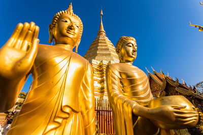 Low angle view of statue against temple building