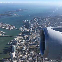 Cropped image of airplane over cityscape