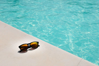 High angle view of sunglasses in swimming pool