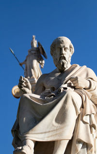 Low angle view of statue against clear blue sky