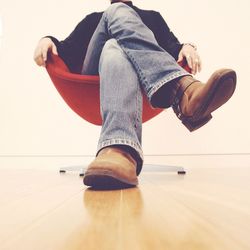 Low section of man sitting on chair