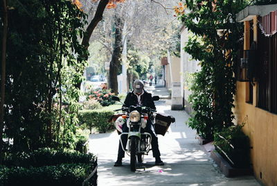 Rear view of man riding motorcycle