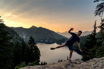 People on mountain against sky during sunset