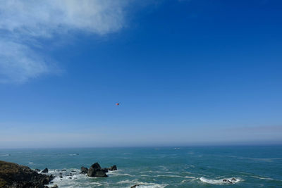 Scenic view of sea against blue sky