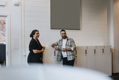 Smiling coworkers talking at break time