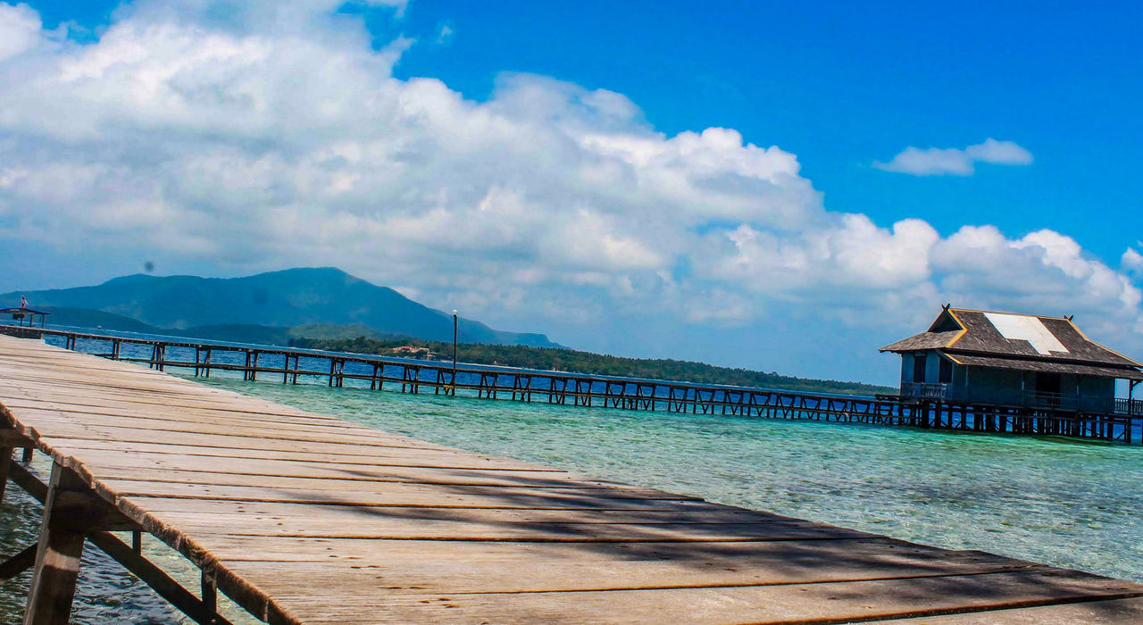 PIER AT SWIMMING POOL AGAINST SKY