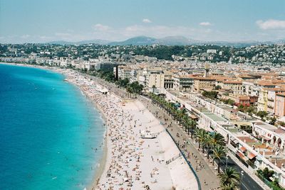 High angle view of townscape by sea against sky