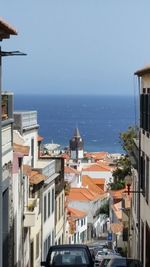 View of city by sea against clear sky