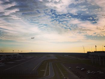 High angle view of airport runway against sky during sunset