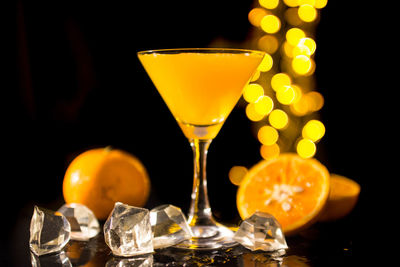 Close-up of beer glass on table against black background