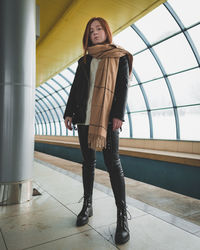 Portrait of woman standing on tiled floor