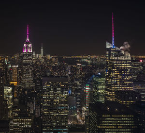 Illuminated cityscape against clear sky at night