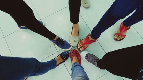 Low section of people standing on tiled floor