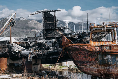 Abandoned ship in water against sky