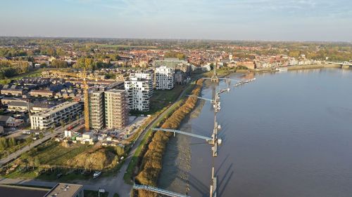 High angle view of river by buildings in city