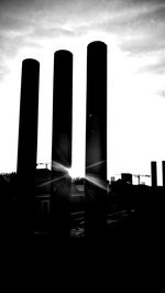 Low angle view of silhouette buildings against sky