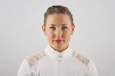 Portrait of young woman against white background