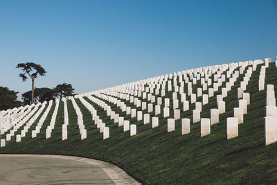 Row of cemetery against clear sky