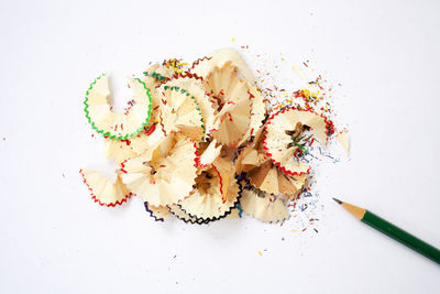 Close-up of multi colored pencils against white background