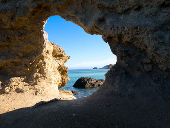 Scenic view of sea seen through arch rock formation