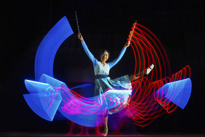 Digital composite image of dancer performing on stage