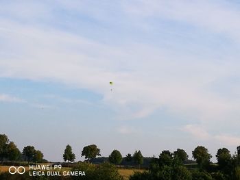 Scenic view of field against cloudy sky