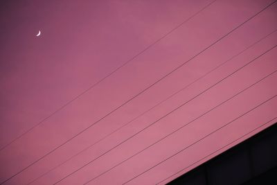 Low angle view of cables against sky at dusk