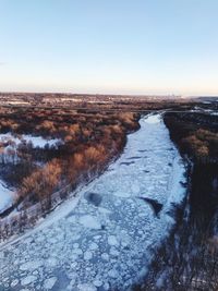 Scenic view of snow covered landscape against clear sky