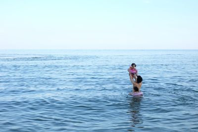 Man surfing in sea against sky