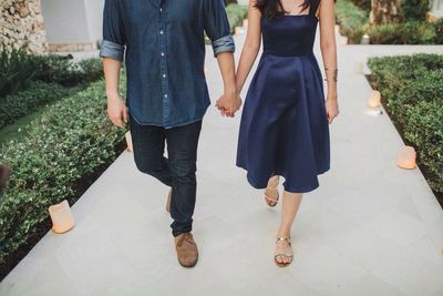 Low section of couple walking on path