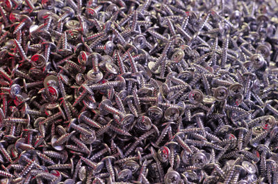 Full frame shot of screws in factory