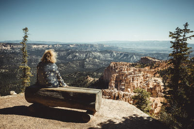 Panoramic view of people looking at mountain against sky