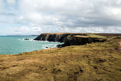 Scenic view of sea against cloudy sky