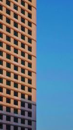 Low angle view of modern building against clear blue sky