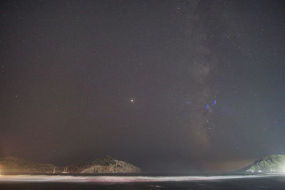 Scenic view of sea against sky at night