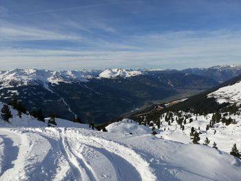 Scenic view of snow covered mountains against sky