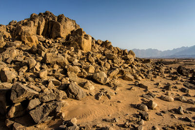 Rock formations on landscape against sky