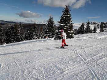 Full length of person skiing on snowcapped mountain against sky