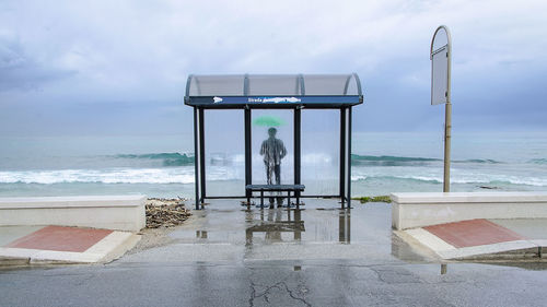 Man at beach against sky