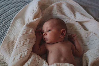 High angle view of baby sleeping on bed at home