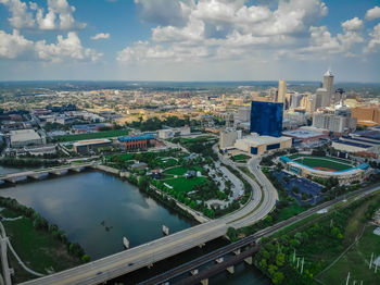 High angle view of river amidst buildings in city against sky