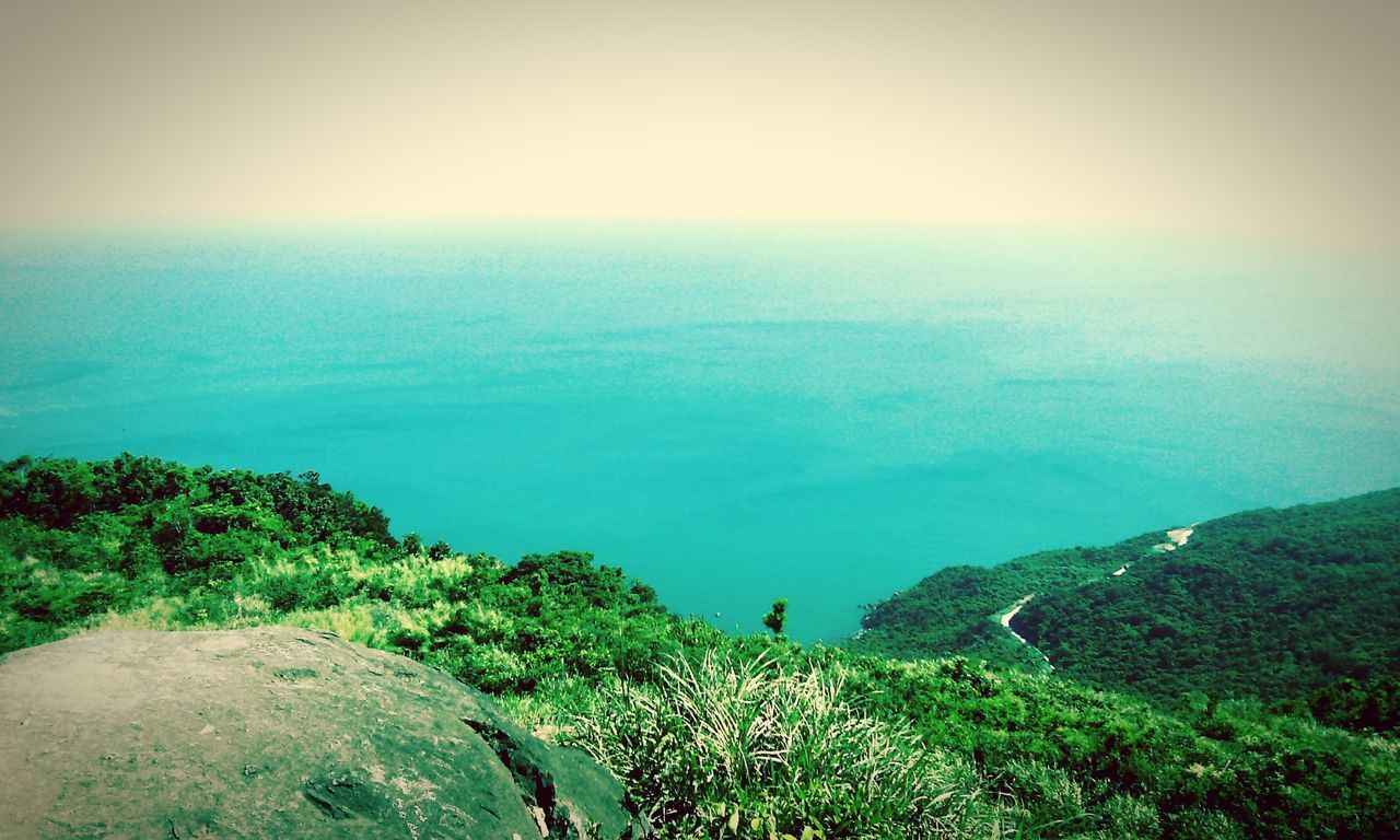 sea, horizon over water, tranquil scene, scenics, tranquility, beauty in nature, water, nature, sky, idyllic, blue, landscape, sunlight, high angle view, coastline, plant, green color, non-urban scene, mountain, clear sky