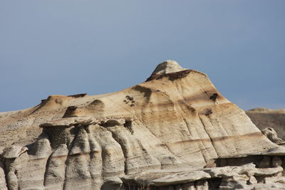 Low angle view of rock formation against clear sky