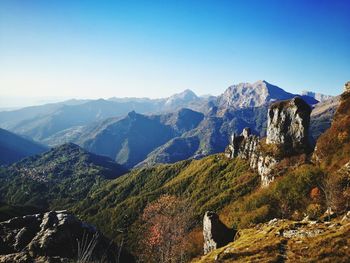 Scenic view of mountains against clear blue sky